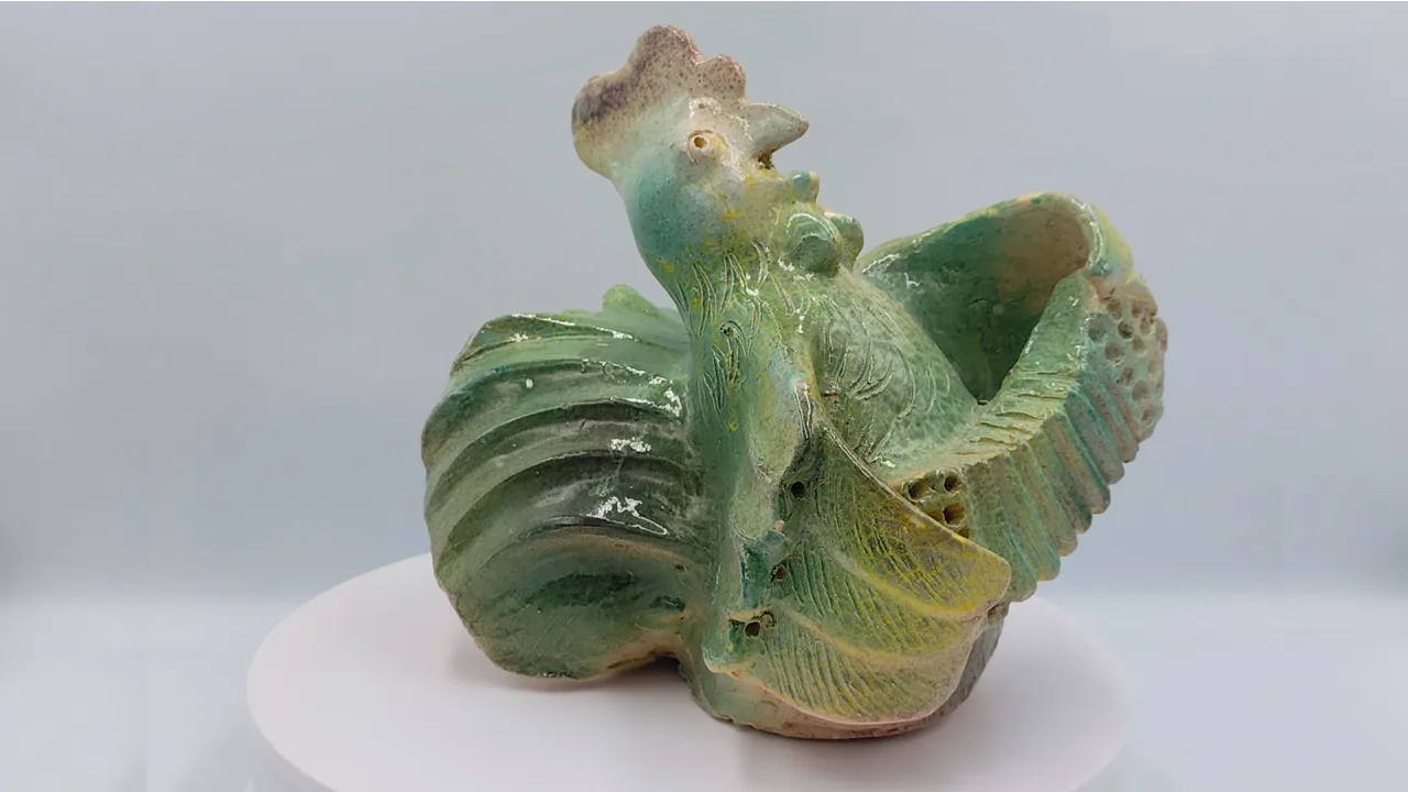Video still showing Slava Romanenko’s ceramic work Accordion-Playing Rooster.