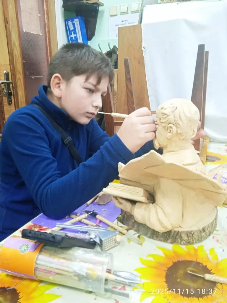 Slava Romanenko modelling the portrait features of a Taras Shevchenko bust in sculpting plasticine.