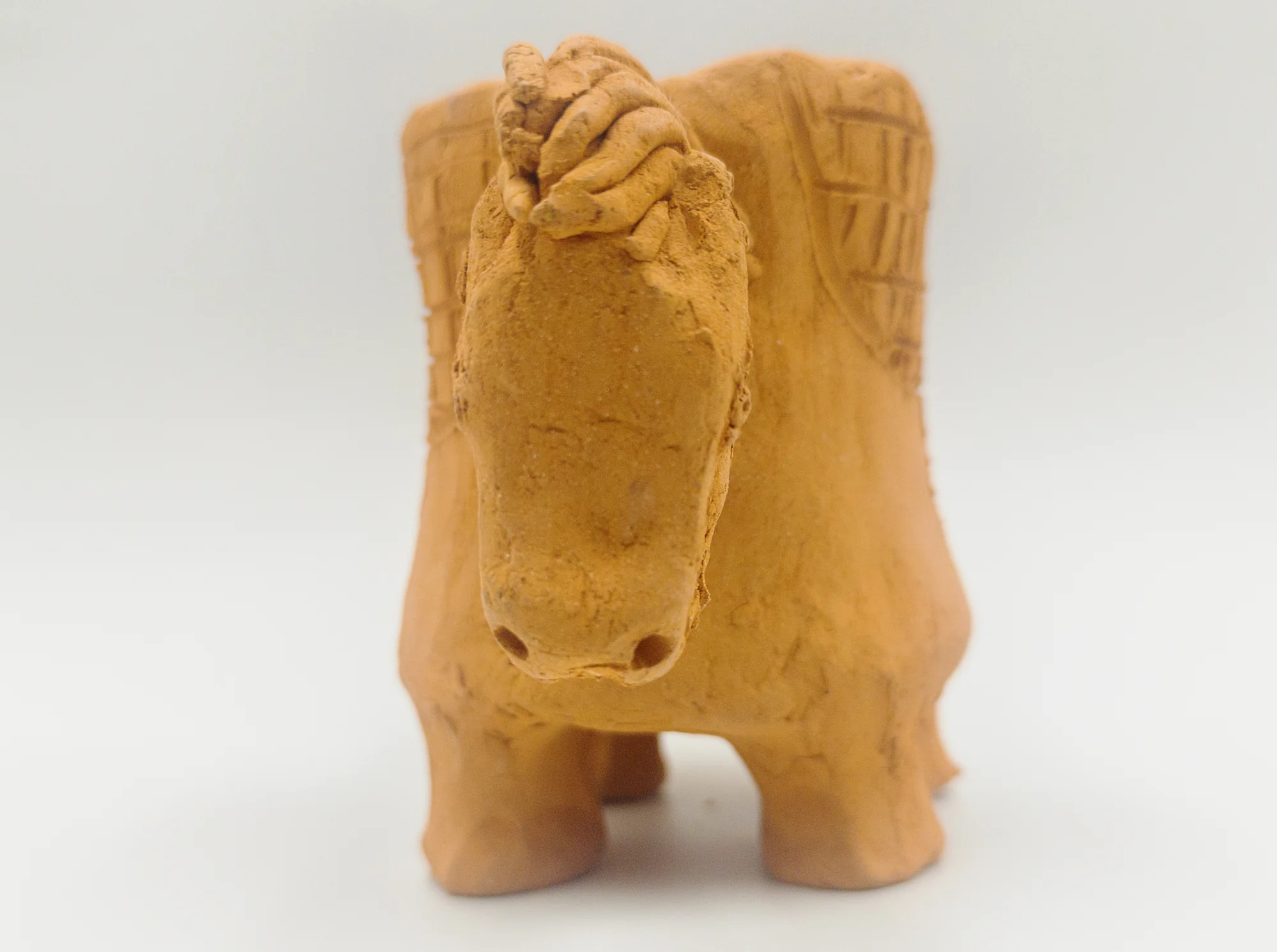 Ceramic work “Horse-Shaped Cup”, front view showing the horse’s head, mane and front legs.