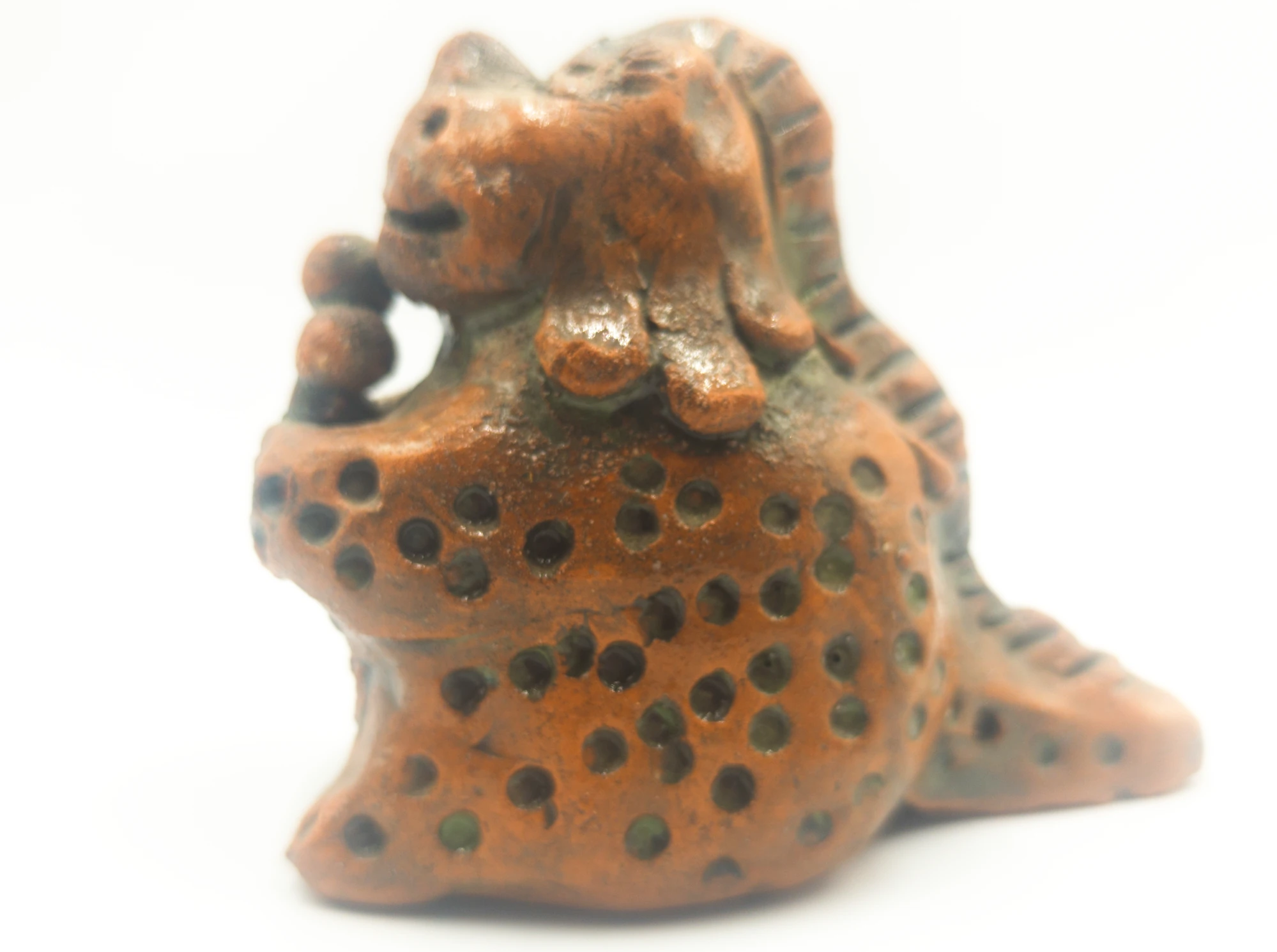 Glazed ceramic dinosaur holding an ice cream cone, a work by Slava Romanenko.
