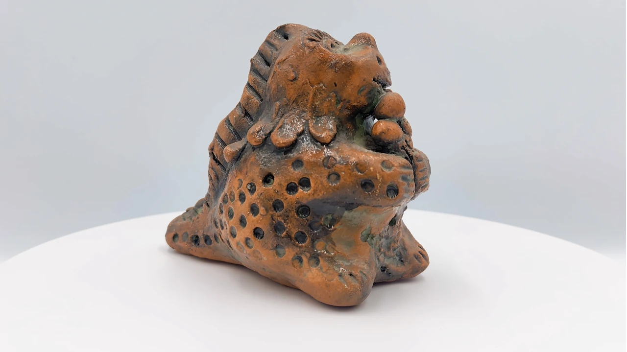 Still from the video overview of Slava Romanenko’s ceramic work “Dinosaur with Ice Cream”.